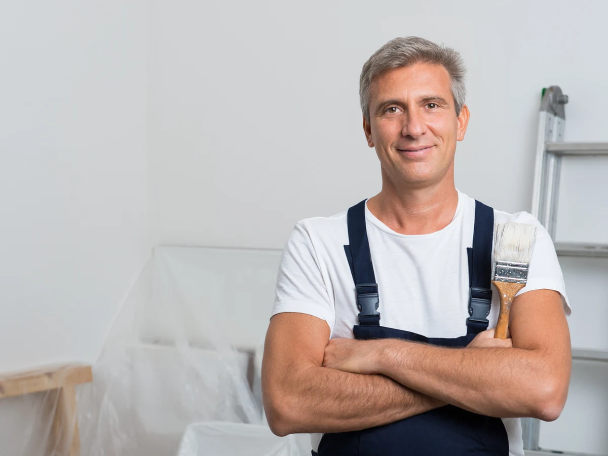 painting-decorating-confident-painter-standing-windsor-decorators Windsor Decorators painter on site at a Virginia Water property